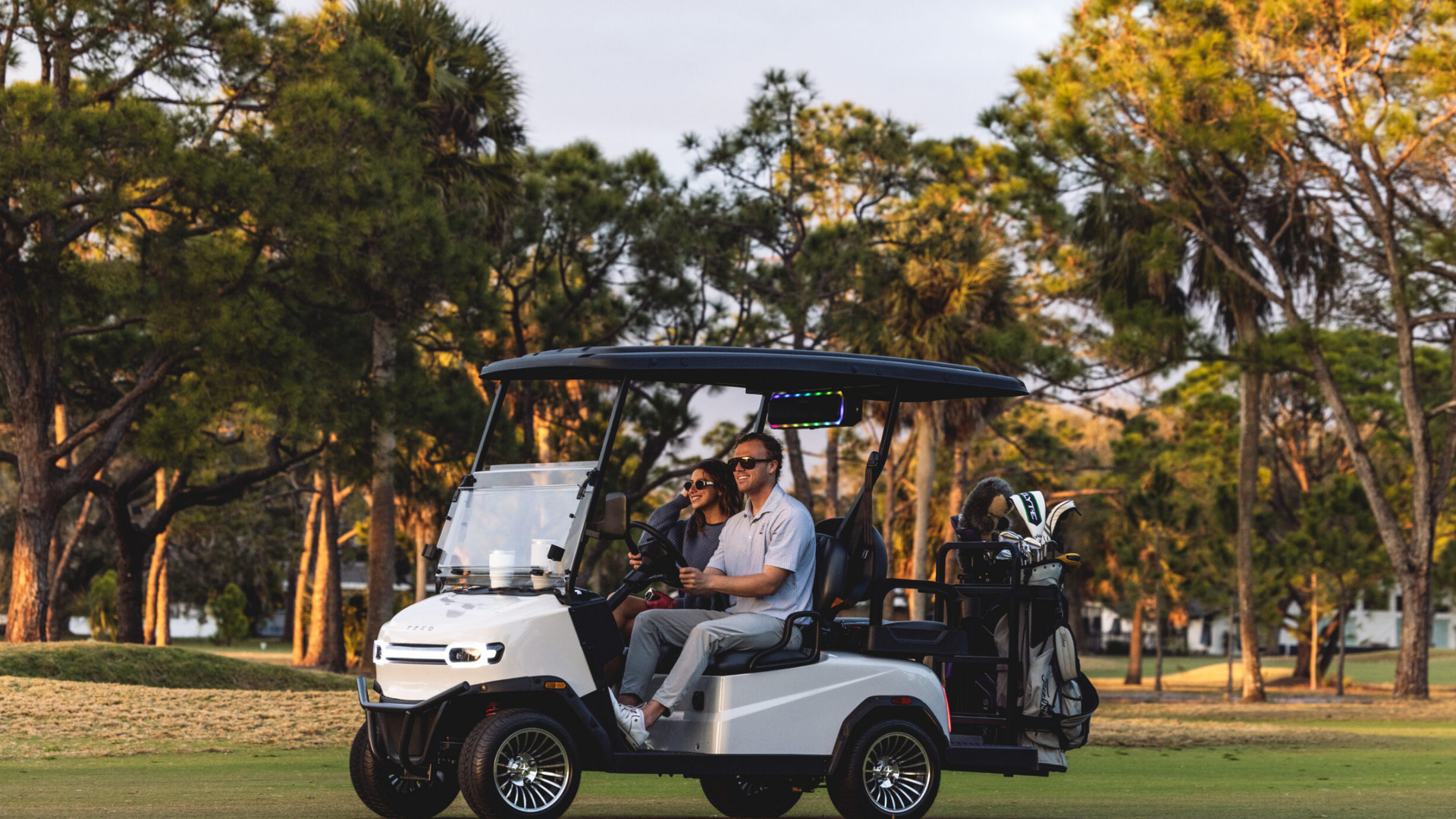 2026 Teko Turbolite golf cart on Rancho Cucamonga course with riders and clubs.