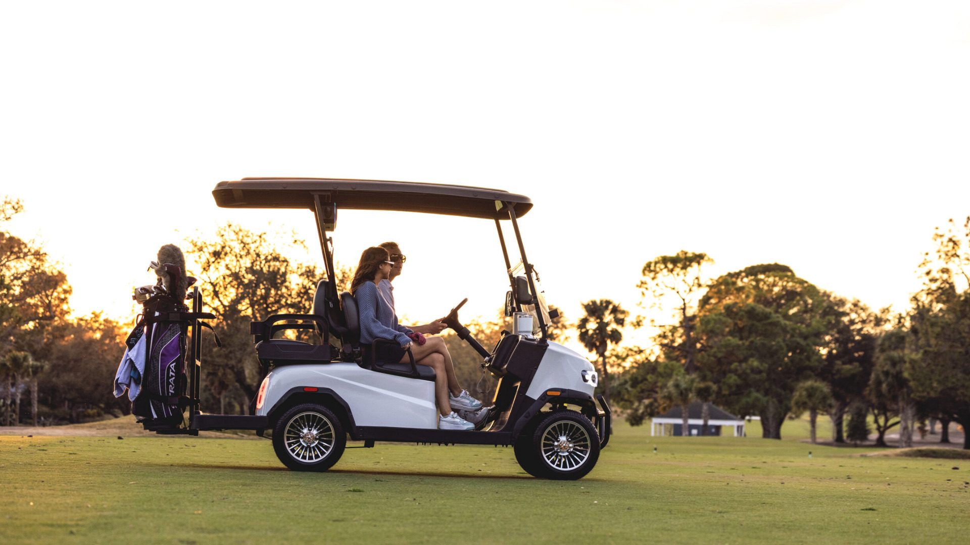 2026 Teko Turbolite parked on Palm Desert golf course with riders and golf bags.