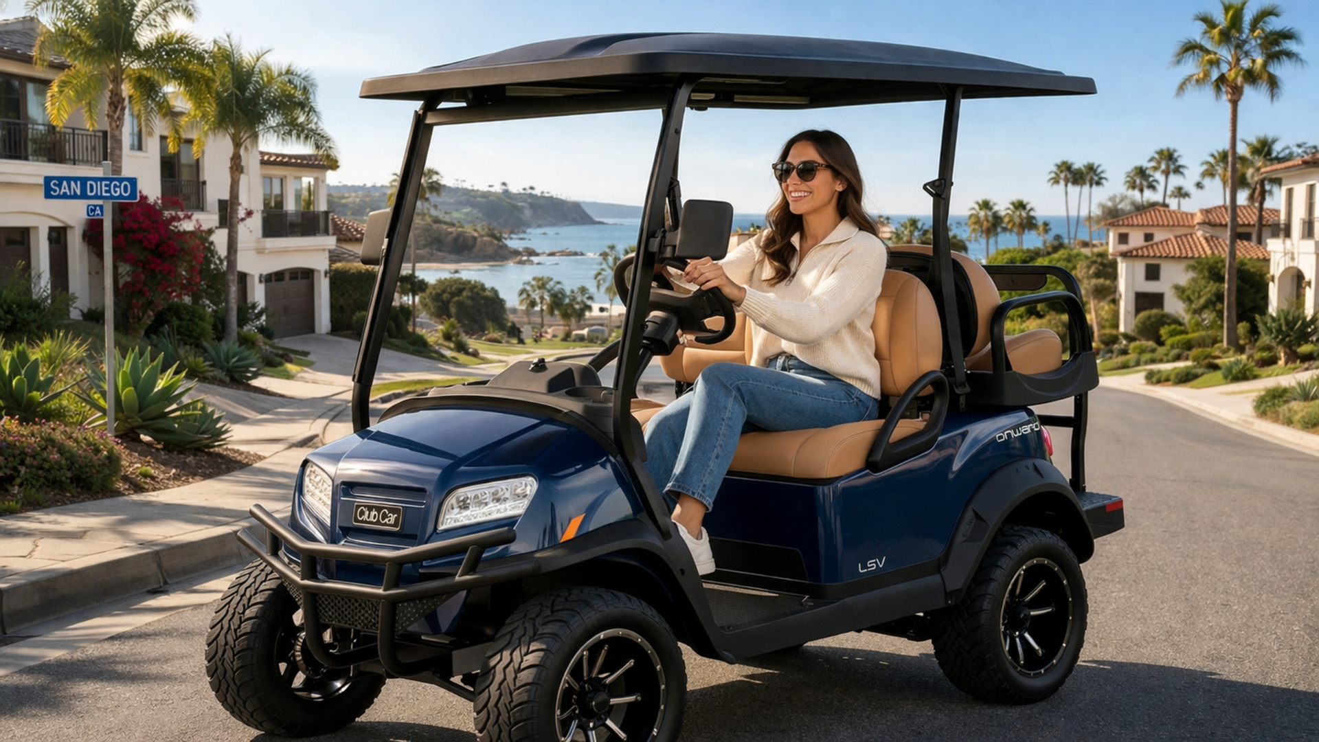 Woman driving navy street legal golf cart on San Diego coastal road with palm trees, hillside homes, and ocean in the background.
